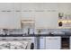 Modern kitchen with black countertops, stainless appliances, and built-in wine storage at 12225 E Cortez Dr, Scottsdale, AZ 85259
