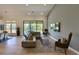 Open living space with a sectional sofa, fireplace, and backyard views at 12225 E Cortez Dr, Scottsdale, AZ 85259