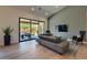 Modern living room featuring a sleek sectional sofa and large sliding glass doors at 12225 E Cortez Dr, Scottsdale, AZ 85259