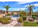 Lounge by the pool surrounded by lush greenery, tall palms, and serene desert plants at 12225 E Cortez Dr, Scottsdale, AZ 85259