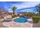 Private pool with covered lounge and desert landscaping offers a serene outdoor space at 12225 E Cortez Dr, Scottsdale, AZ 85259