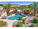 Backyard features a sparkling pool, covered patio, and desert landscaping with mountain views at 12225 E Cortez Dr, Scottsdale, AZ 85259
