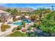 Backyard pool with a manicured lawn, mature landscaping, and an outdoor lounge area at 12225 E Cortez Dr, Scottsdale, AZ 85259