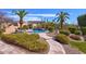 Beautiful walkway leads to a backyard featuring a pool, covered patio, and desert landscaping at 12225 E Cortez Dr, Scottsdale, AZ 85259