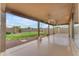 Spacious covered back patio with ceiling fans overlooking the well-maintained yard at 14010 N 126Th Ave, El Mirage, AZ 85335