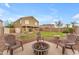 Private backyard featuring a fire pit, outdoor seating, and lush landscaping at 14010 N 126Th Ave, El Mirage, AZ 85335