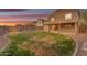 Beautiful backyard at twilight, complete with a cozy fire pit and seating area at 14010 N 126Th Ave, El Mirage, AZ 85335