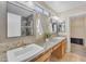 Bathroom with double sinks, mirrors, and natural light, offers a practical yet appealing space at 14010 N 126Th Ave, El Mirage, AZ 85335