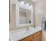 Bright bathroom vanity with white countertop, framed mirror, and modern lighting at 14010 N 126Th Ave, El Mirage, AZ 85335