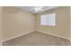 Cozy bedroom featuring neutral carpet, ceiling fan, and a bright window at 14010 N 126Th Ave, El Mirage, AZ 85335