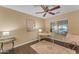 Bright bedroom features stylish decor, a ceiling fan, and a window with natural light at 14010 N 126Th Ave, El Mirage, AZ 85335