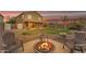 Cozy backyard fire pit surrounded by seating, ideal for outdoor entertaining and relaxation at 14010 N 126Th Ave, El Mirage, AZ 85335