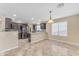 Bright, open kitchen featuring a breakfast bar, stainless steel appliances, and tile flooring at 14010 N 126Th Ave, El Mirage, AZ 85335