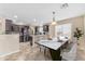 Open concept kitchen with stainless steel appliances, a dining table and natural light streaming through window at 14010 N 126Th Ave, El Mirage, AZ 85335