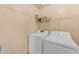 Functional laundry room with white washer and dryer, and storage shelving at 14010 N 126Th Ave, El Mirage, AZ 85335