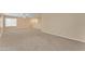 Spacious living room showcasing neutral carpet, ample natural light, and an inviting atmosphere at 14010 N 126Th Ave, El Mirage, AZ 85335