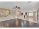 Open-concept living area with hardwood floors, stairs, and a seamless transition to the kitchen at 14010 N 126Th Ave, El Mirage, AZ 85335