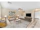 Bright living room featuring a ceiling fan, a comfortable couch, and stairs to the second floor at 14010 N 126Th Ave, El Mirage, AZ 85335