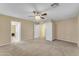 Neutral bedroom showing ceiling fan, carpet, and entry to closet and bathroom at 14010 N 126Th Ave, El Mirage, AZ 85335