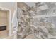 Beautiful walk-in shower boasts custom tile, rain shower head, and convenient grab bar at 14010 N 126Th Ave, El Mirage, AZ 85335