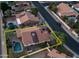 Aerial view of a home with a private pool and spa, bordered by lush greenery, and a yellow property outline at 14248 N 56Th Pl, Scottsdale, AZ 85254