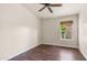 The bedroom in this home offers hardwood floors and a window looking out onto the neighborhood at 14248 N 56Th Pl, Scottsdale, AZ 85254