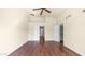 This bedroom boasts hardwood floors, a ceiling fan, and doorways to the home's other rooms at 14248 N 56Th Pl, Scottsdale, AZ 85254