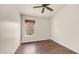 Small bedroom featuring hardwood floors and a window looking out onto the neighborhood at 14248 N 56Th Pl, Scottsdale, AZ 85254
