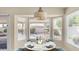 Bright dining area featuring a round table, backyard views, and natural light from three windows at 14248 N 56Th Pl, Scottsdale, AZ 85254