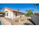 Spacious backyard featuring a pool, gravel landscaping, and the house's exterior at 14248 N 56Th Pl, Scottsdale, AZ 85254
