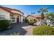 This home has a manicured front yard with desert landscaping and a palm tree at 14248 N 56Th Pl, Scottsdale, AZ 85254