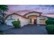 Inviting single-story home with an attached garage, brick-paved driveway, and appealing front yard landscaping at 14248 N 56Th Pl, Scottsdale, AZ 85254