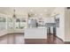 Bright kitchen featuring white cabinets, stainless steel appliances, a large island, and a mosaic tile backsplash at 14248 N 56Th Pl, Scottsdale, AZ 85254