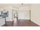 Open-concept living room with hardwood floors, access to kitchen, and vaulted ceiling at 14248 N 56Th Pl, Scottsdale, AZ 85254