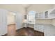 Office with hardwood flooring, built-in cabinets, desk, and an open door to an adjacent room at 14248 N 56Th Pl, Scottsdale, AZ 85254