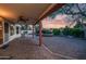 Covered patio overlooking a beautiful backyard with a pool, spa, and lush landscaping at 14248 N 56Th Pl, Scottsdale, AZ 85254