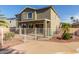 Backyard view featuring a white fence, covered patio, and desert landscaping, offering privacy and space at 15010 W Hope Dr, Surprise, AZ 85379