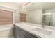 Bathroom with double sink vanity, soaking tub, and glass enclosed shower at 15010 W Hope Dr, Surprise, AZ 85379