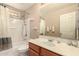 Bathroom with a tub-shower combo, light wood vanity, and neutral tones, offering a relaxing ambiance at 15010 W Hope Dr, Surprise, AZ 85379