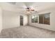 Inviting bedroom with plush carpet, ceiling fan, and sunny windows at 15010 W Hope Dr, Surprise, AZ 85379