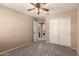 Neutral bedroom boasts gray carpet flooring and a closet with white doors, offering ample storage space at 15010 W Hope Dr, Surprise, AZ 85379