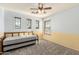 Comfortable bedroom features blue and yellow color blocking and three windows for natural light at 15010 W Hope Dr, Surprise, AZ 85379