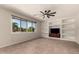 Spacious bonus room featuring built-in shelving, a ceiling fan, and tile flooring, ideal for entertaining at 15010 W Hope Dr, Surprise, AZ 85379