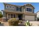 Charming two-story home featuring a well-maintained yard, desert landscaping, and a welcoming front porch at 15010 W Hope Dr, Surprise, AZ 85379