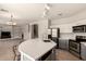 Spacious kitchen with stainless steel appliances, island with bar seating, open to living area at 15010 W Hope Dr, Surprise, AZ 85379