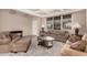 Bright and inviting living room with comfortable seating, neutral colors, and ample natural light at 15010 W Hope Dr, Surprise, AZ 85379