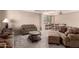 Cozy living room featuring neutral tones, plush seating, and a dining area, creating a welcoming space at 15010 W Hope Dr, Surprise, AZ 85379