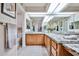 Spacious bathroom featuring granite countertops, dual sinks, and oak cabinetry at 17404 N 99Th Ave # 318, Sun City, AZ 85373