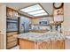 Well-lit kitchen features oak cabinets, stainless steel appliances, and a breakfast bar at 17404 N 99Th Ave # 318, Sun City, AZ 85373