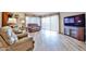 Bright living room featuring hardwood floors, large windows, and comfortable seating at 17404 N 99Th Ave # 318, Sun City, AZ 85373